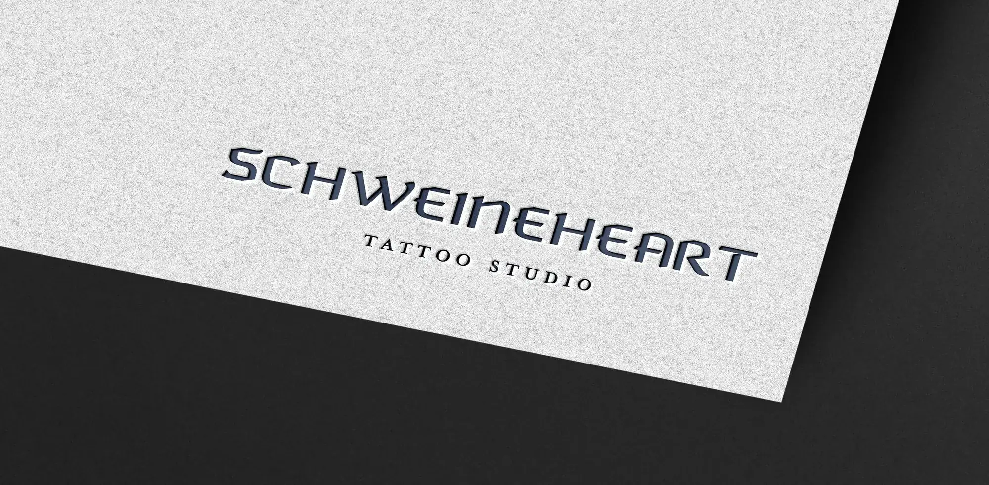 Schweineheart Tattoo Studio logo embossed on white paper