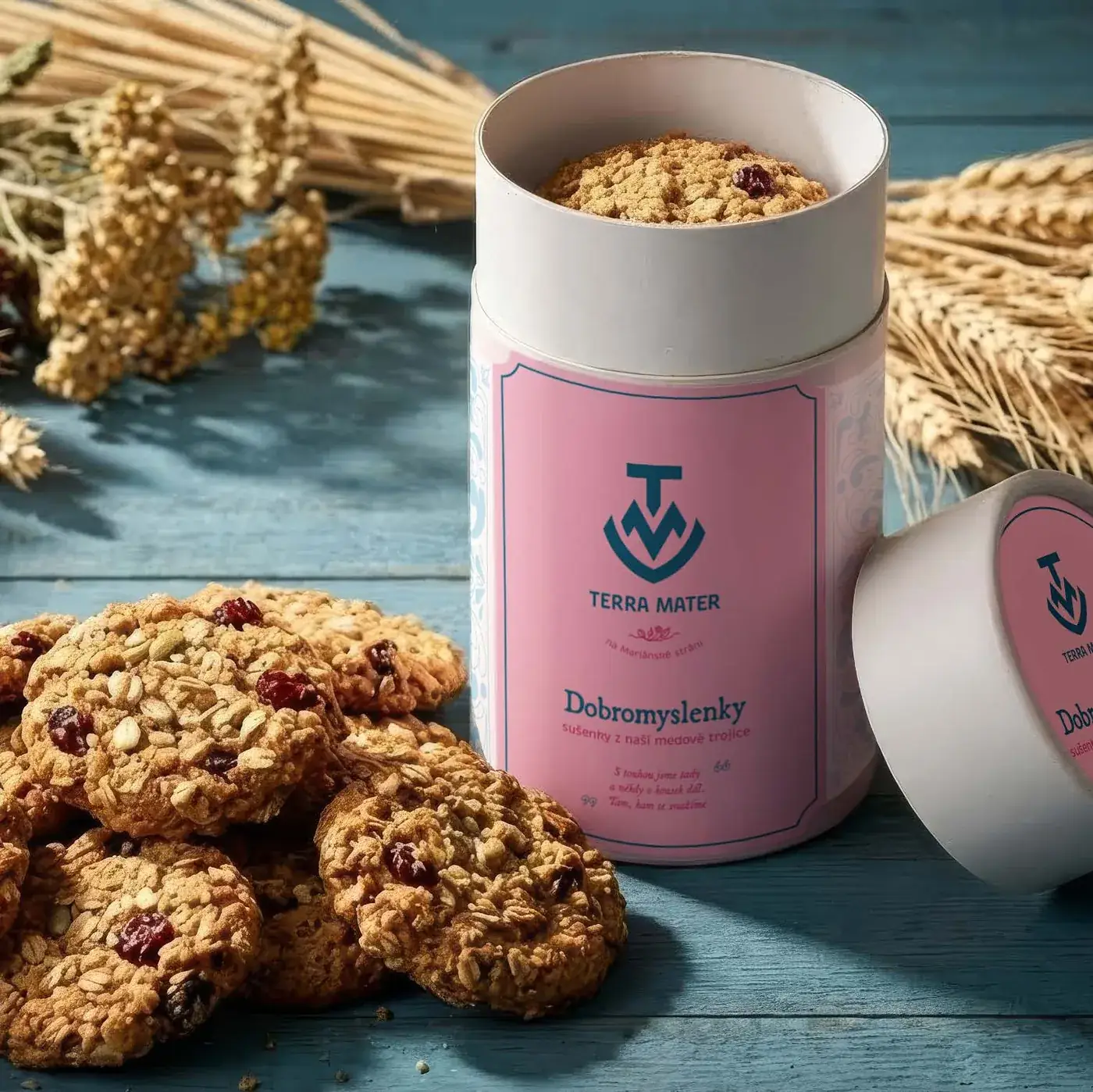 Pink Terra Mater tin surrounded by cookies and wheat